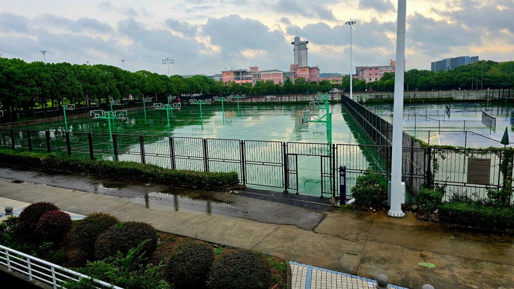 Ten basketball courts, five tennis courts and a running track with a playing field in the middle. The pink buildings hold my classrooms.